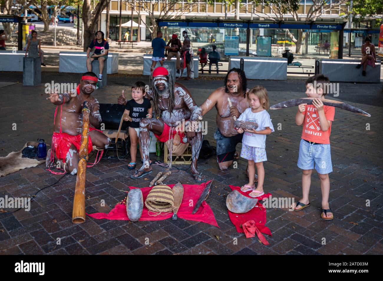 Sydney, NSW, Australia February 1, 2020: A group of talented Aboriginals play wooden clapsticks and didgeridoo for tourists at Circular Quay. Stock Photo