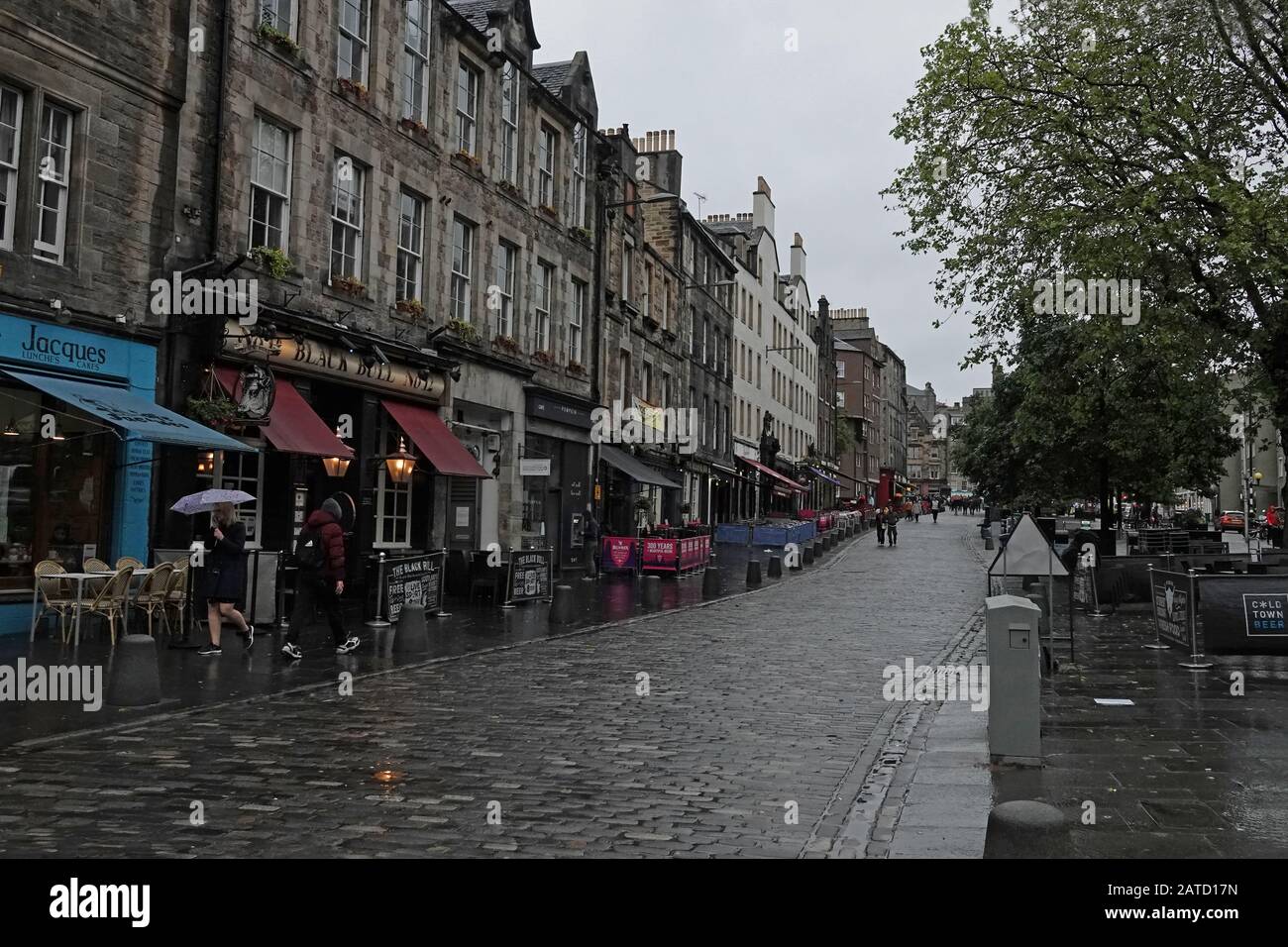 Edinburgh, Scotland / UK - June 12, 2019: Pubs and shops along the Grassmarket district are shown during a rainy day. For editorial uses only. Stock Photo