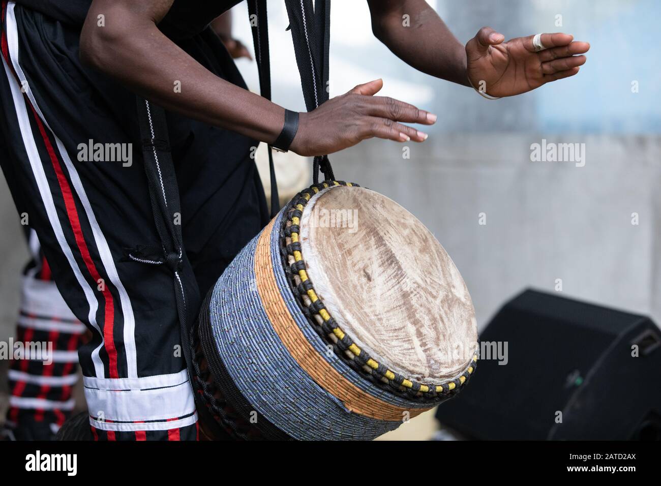 Closeup of african man wearing stripped pant and performing traditional