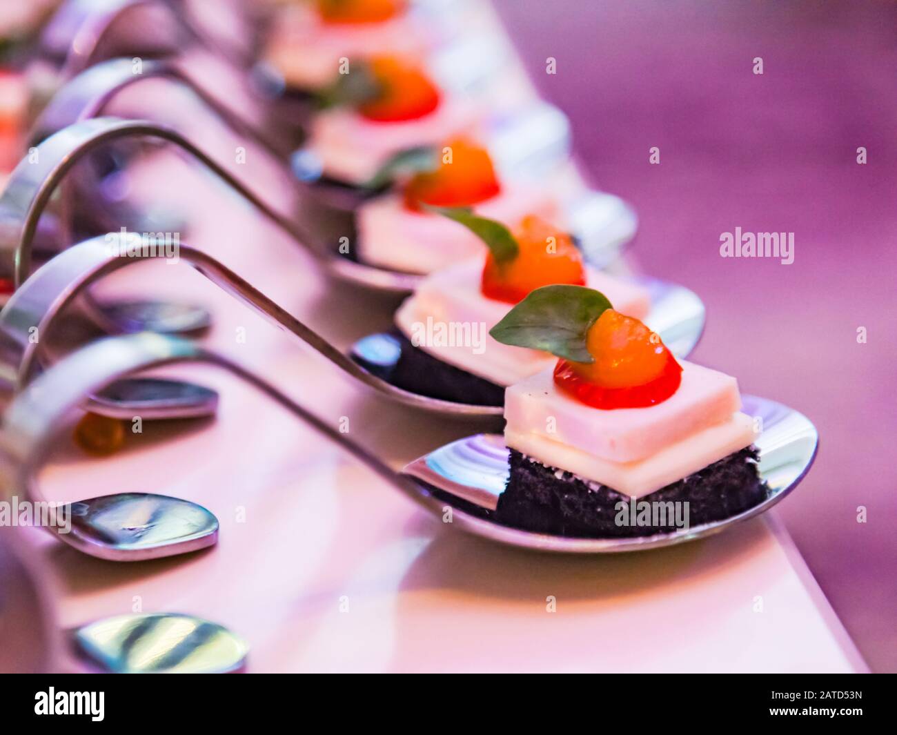 Decorated White Chocolate Cake dessert serving in spoons on Hotel