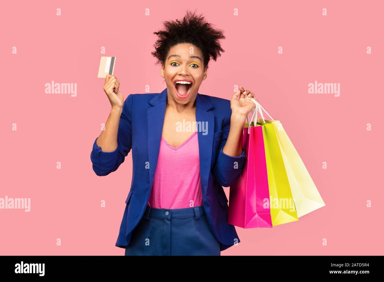 Cheerful afro girl with shopping bags and plastic card Stock Photo
