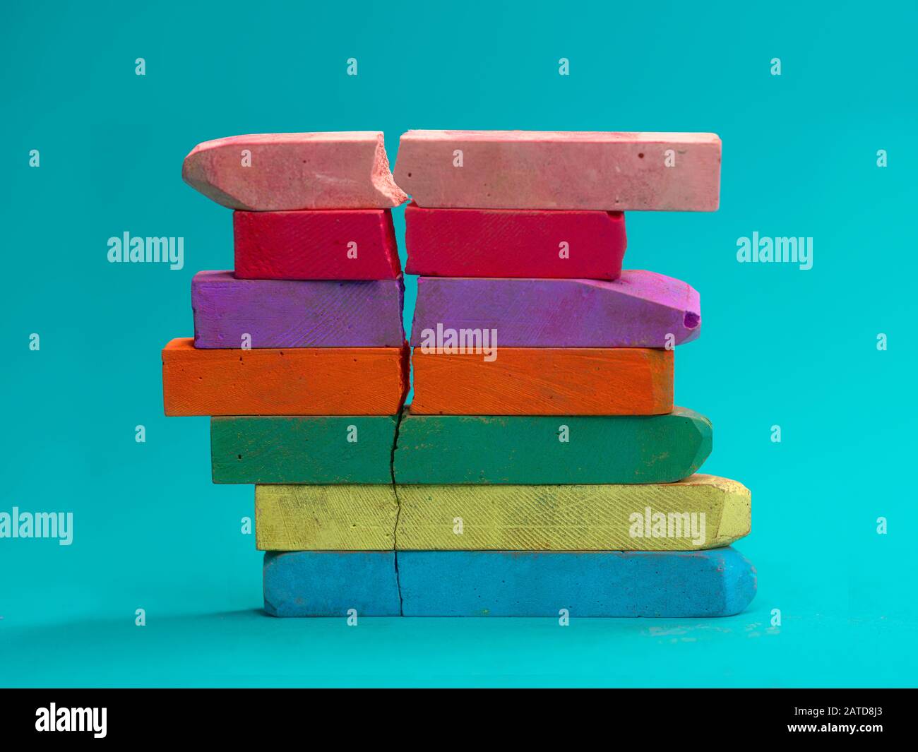 Stack of multi coloured chalk with a crack in Stock Photo