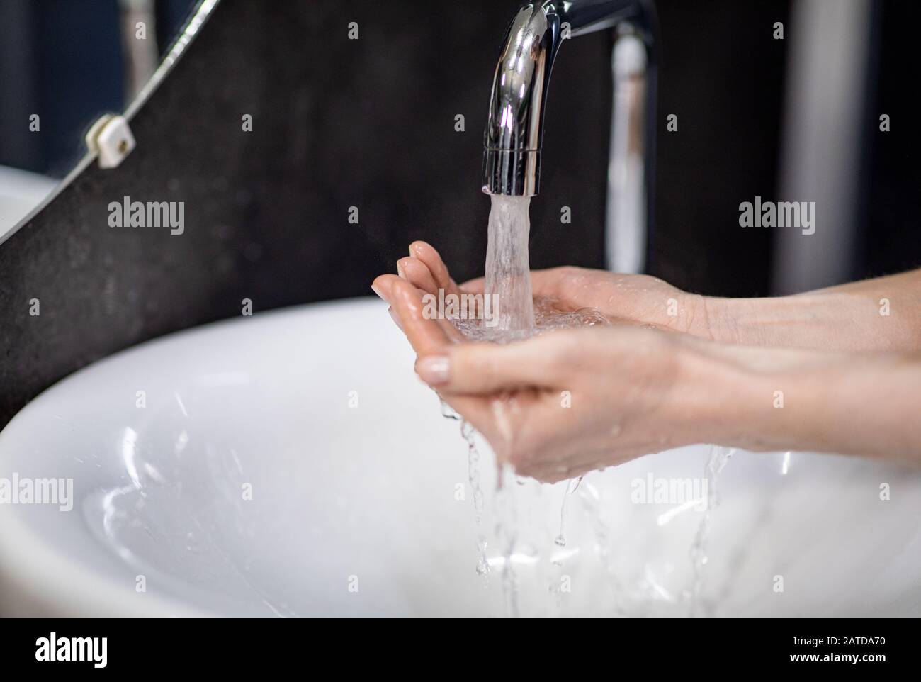 Unrecognizable Mature Woman Washing Hands In Bathroom, Selective Focus Stock Photo