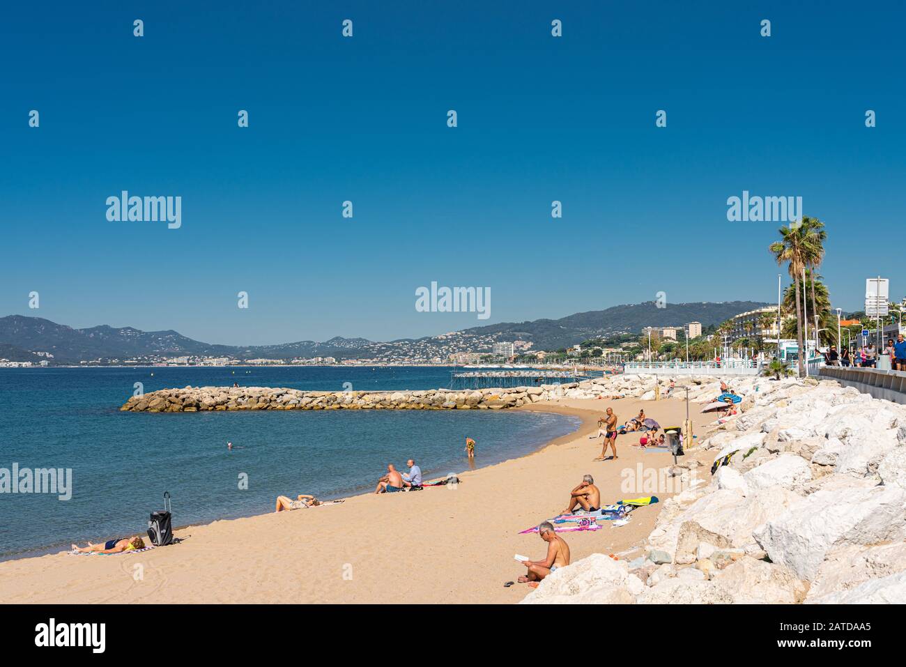 CANNES, FRANCE - JUNE 01, 2019: People Having Fun On Cannes City Beach At The Mediterranean Sea Stock Photo