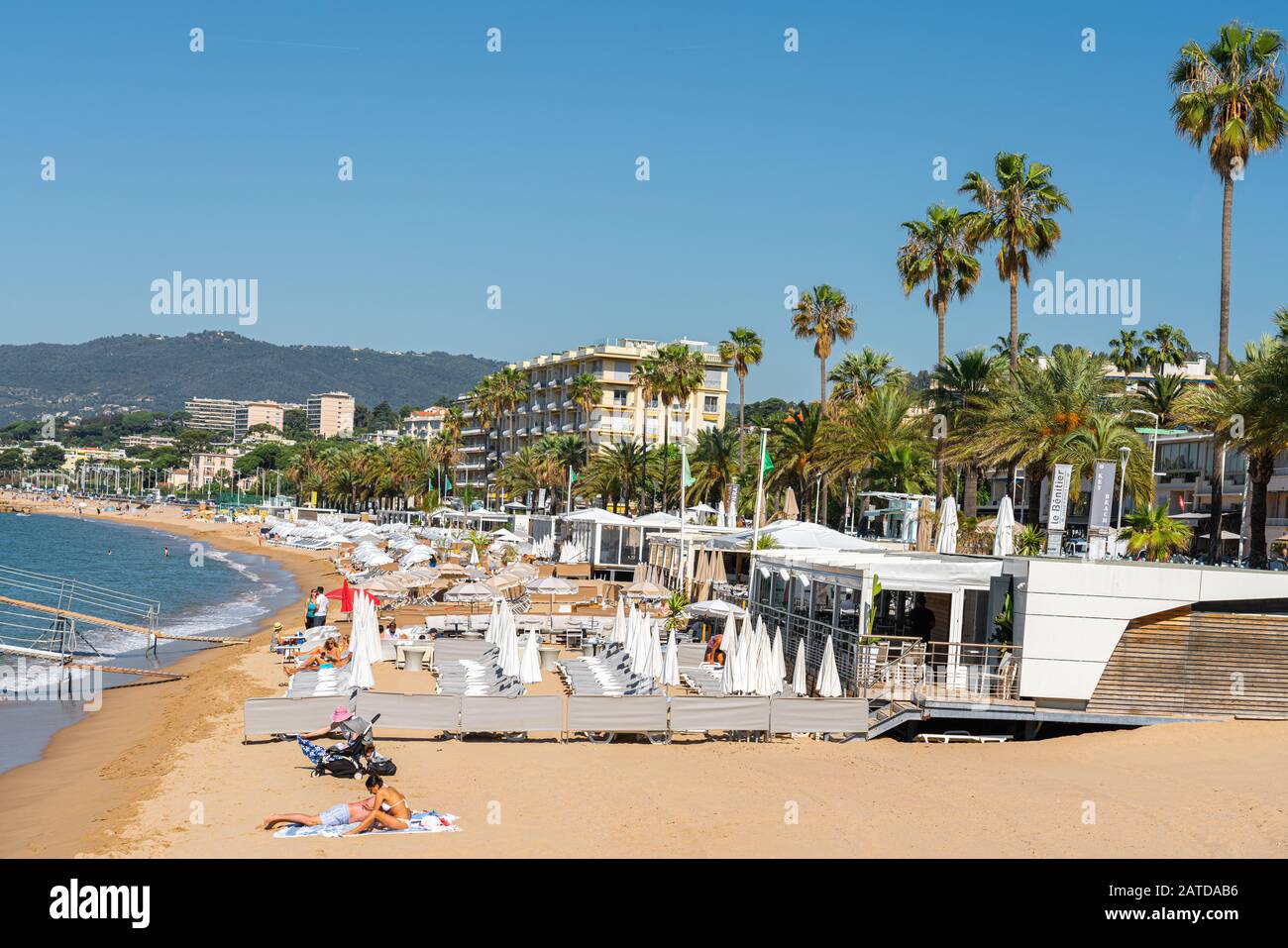 CANNES, FRANCE - JUNE 01, 2019: People Having Fun On Cannes City Beach At The Mediterranean Sea Stock Photo