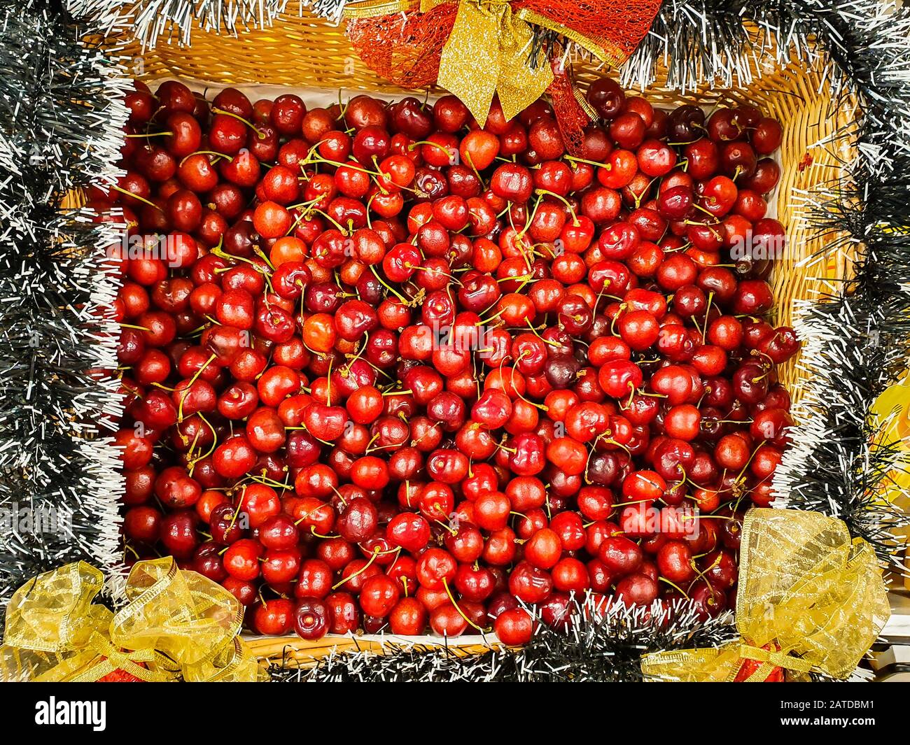 Overhead view of fresh cherries in a Christmas basket Stock Photo