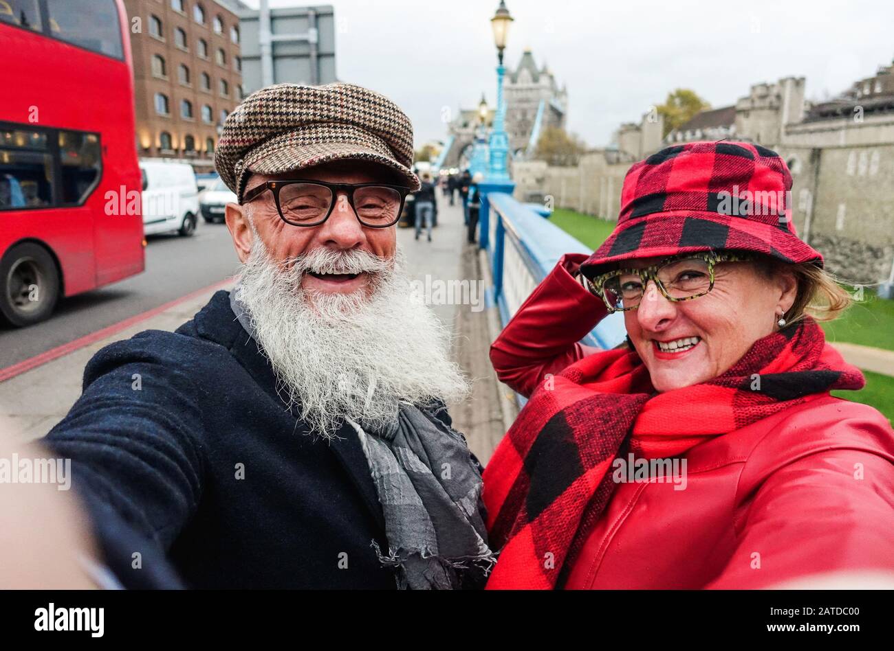Happy senior couple taking selfie in london - Old trendy people having fun with technology trends - Travel and joyful elderly lifestyle concept - Main Stock Photo
