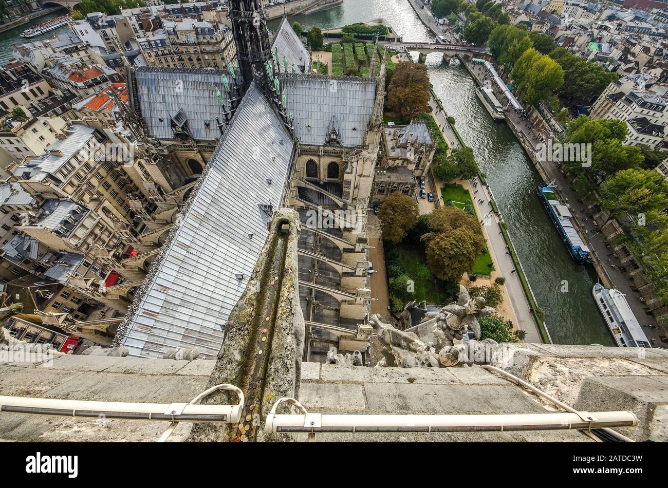 At the top of Cathedral of Notre Dame, Paris, France. View to steeple of church, Seine river, bridges. Stock Photo