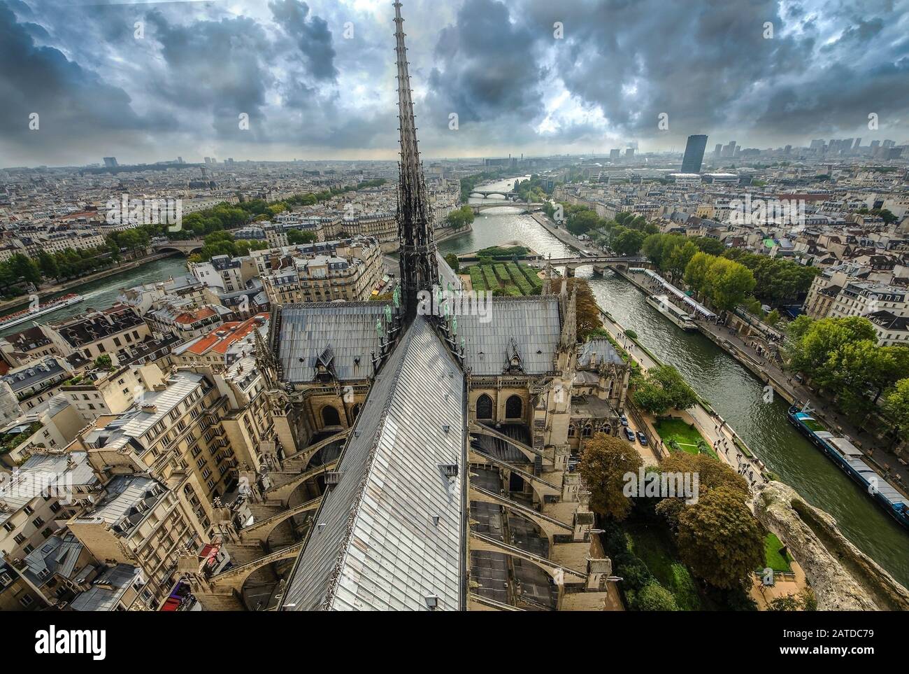 At the top of Cathedral of Notre Dame, Paris, France. View to steeple of church, Seine river, bridges. Stock Photo