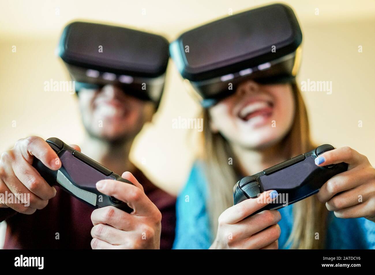 Young funny couple playing video games virtual reality glasses in their  apartment - Happy people having fun with new trends technology - Gaming  concep Stock Photo - Alamy
