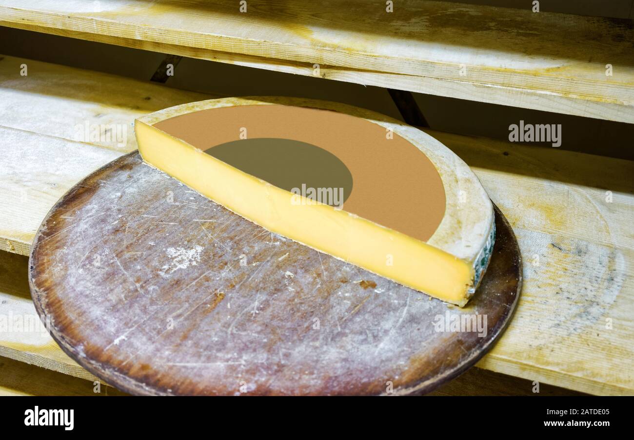 Slice of Aging Gruyere de Cheese on wooden shelves Stock Photo Alamy