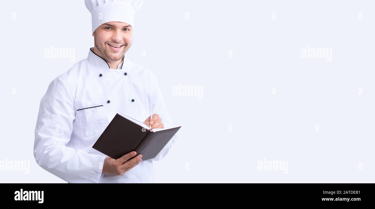 Chef Guy Writing Recipes Standing Over White Background, Panorama Stock Photo