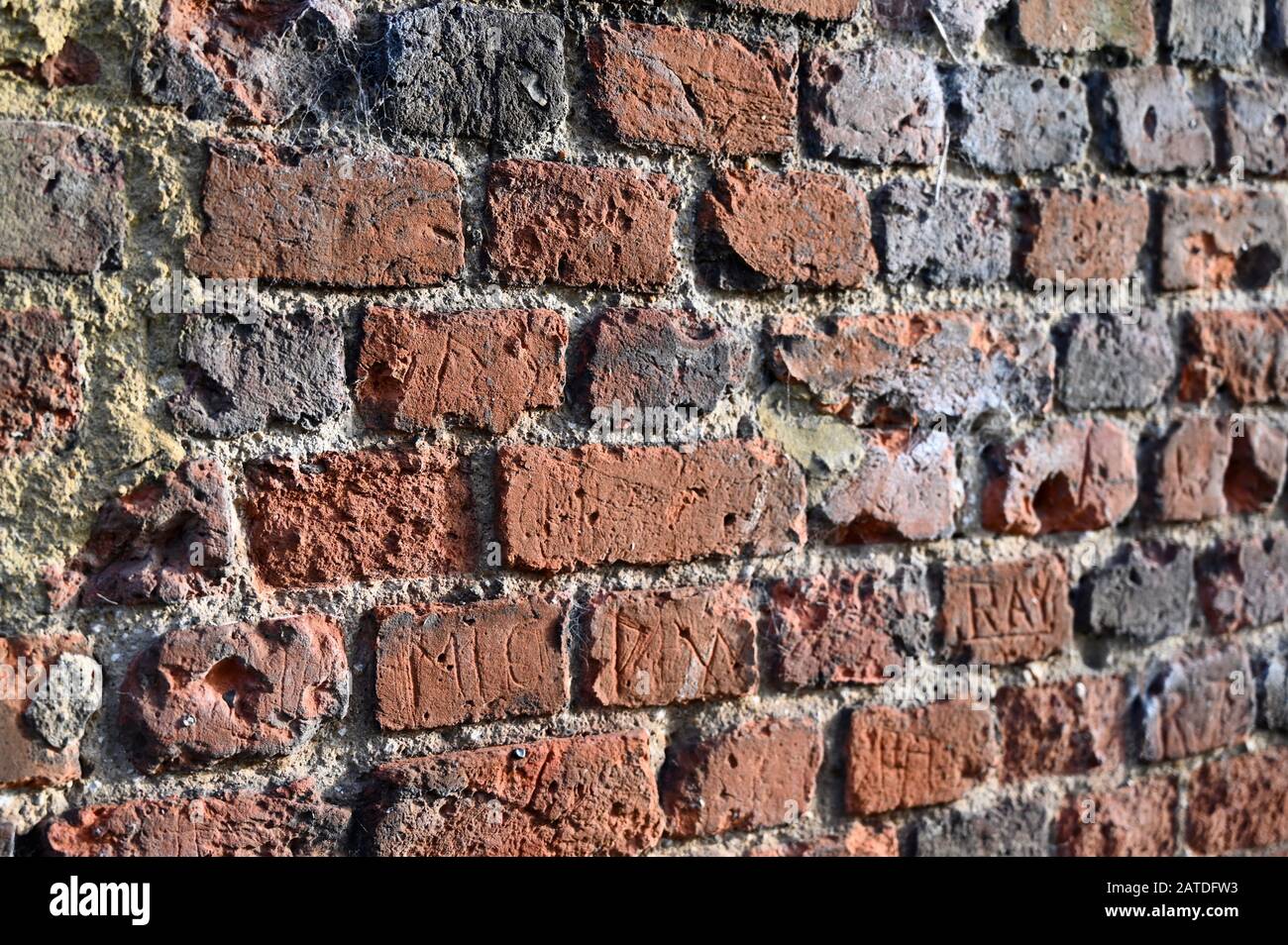 Deteriorating Old Brick Wall, The Parish Church of St James, North Cray, Footscray Meadows, Sidcup, Kent. UK Stock Photo