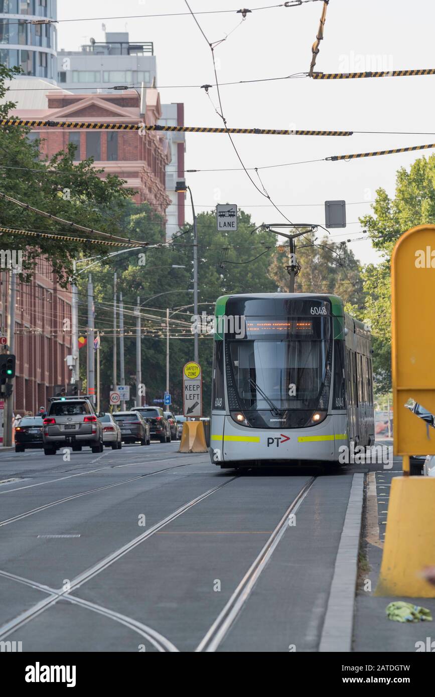 A modern Melbourne tram number 6048 on a weekend city route in Australia. Tram tracks visible in the road. Stock Photo