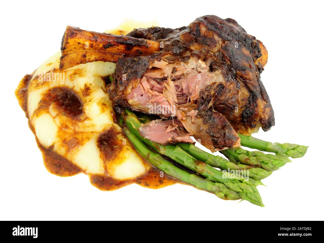 Slow cooked lamb shank meal with creamy mashed potato and asparagus