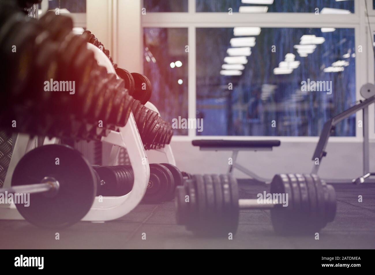 empty sport fitness gym club at night with window and iron barbells Stock  Photo - Alamy