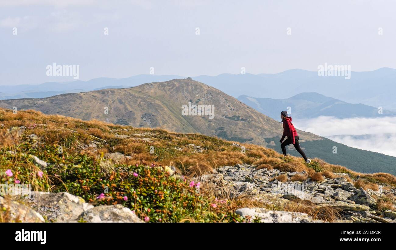 Women Ridge Woman is climbing a mountain ridge. Woman going through a stone valley ...