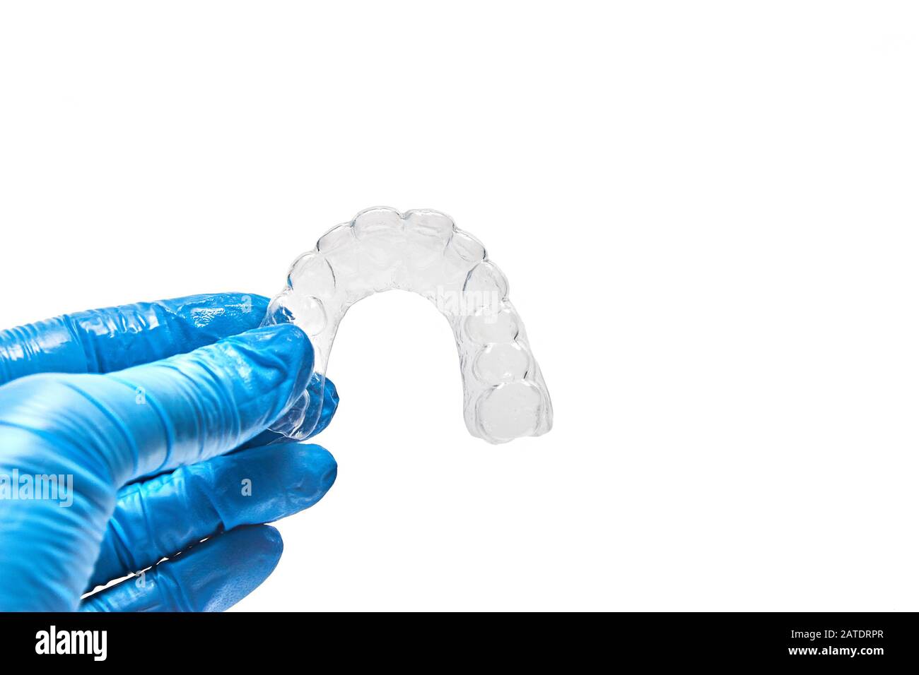 Hand holding individual dental tray for bleaching teeth Isolated on a white background Stock Photo