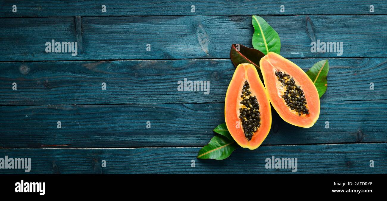Tropical fruits, sweet papaya, raw vegan food on a blue wooden background. Top view. Free space for text. Stock Photo