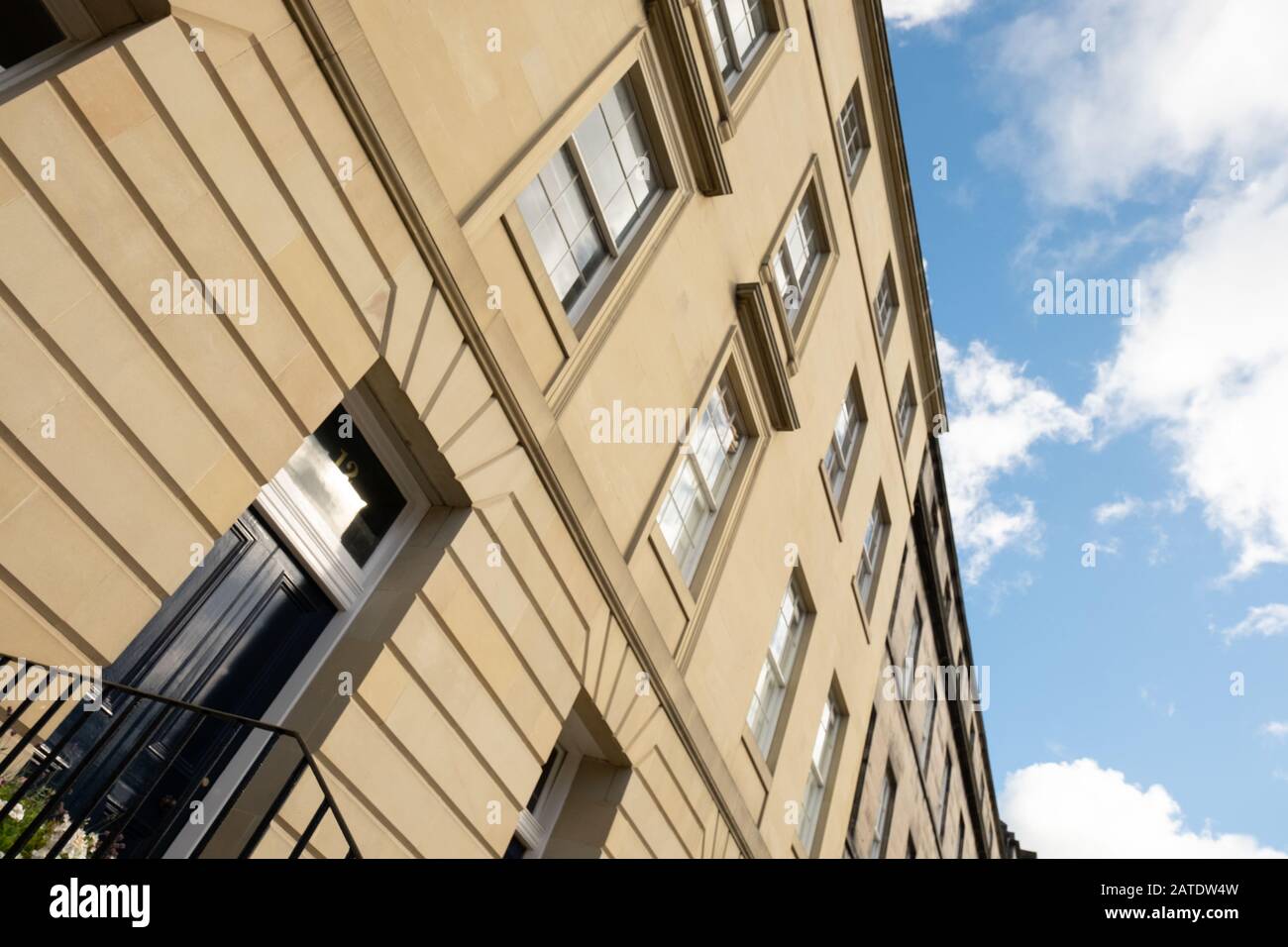 Looking up at yellow sandstone front of 4 storey house in Edinburgh, Scotland Stock Photo