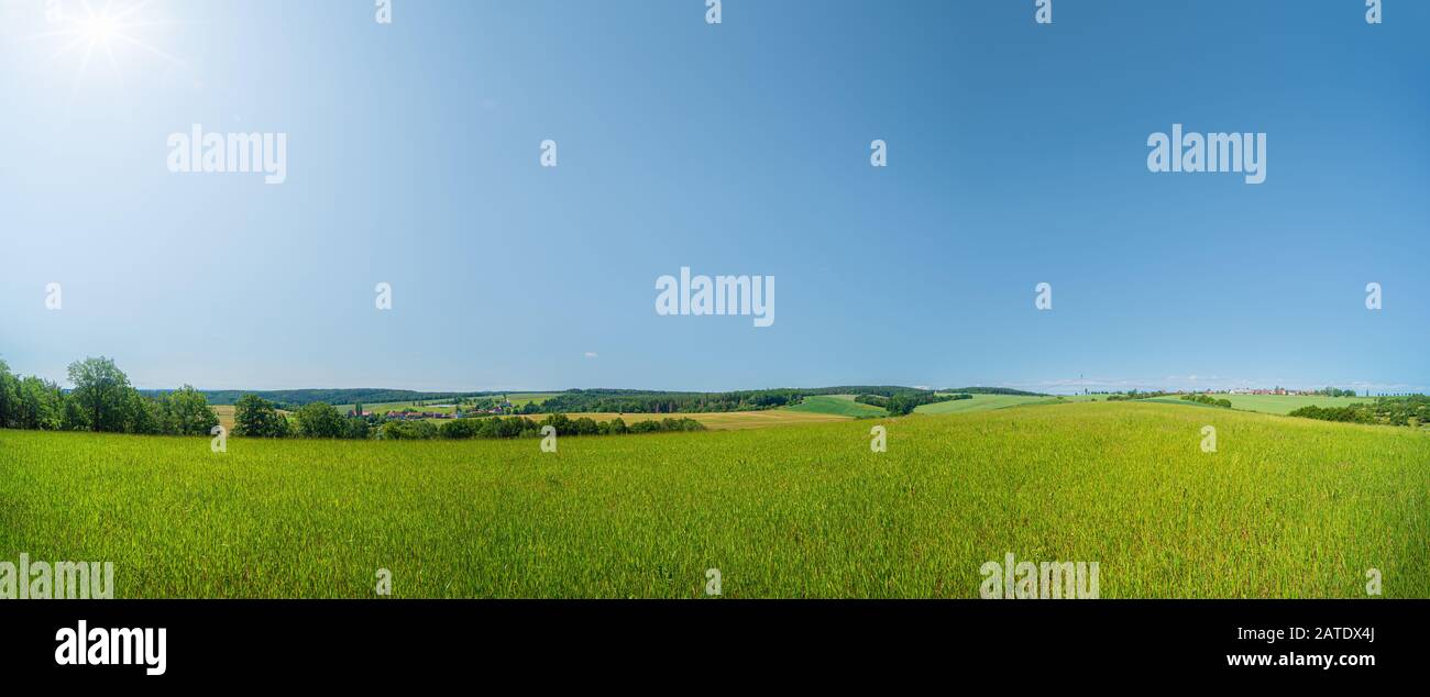 green meadow under the blue sky. Farmland view in Europe Stock Photo ...