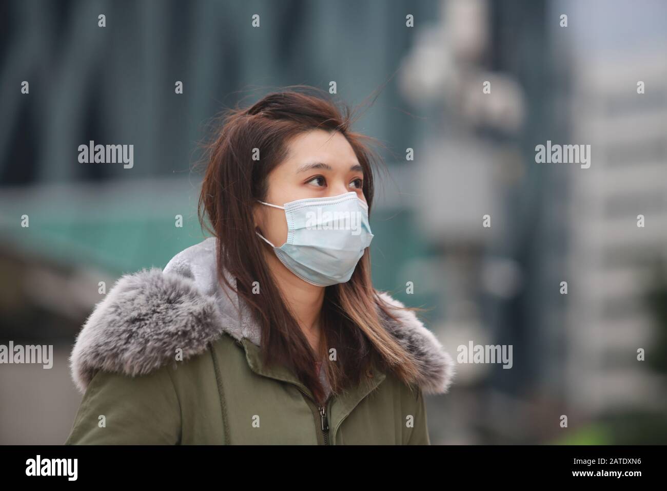 masked girl to protect herself from wuhan virus in public area Stock ...