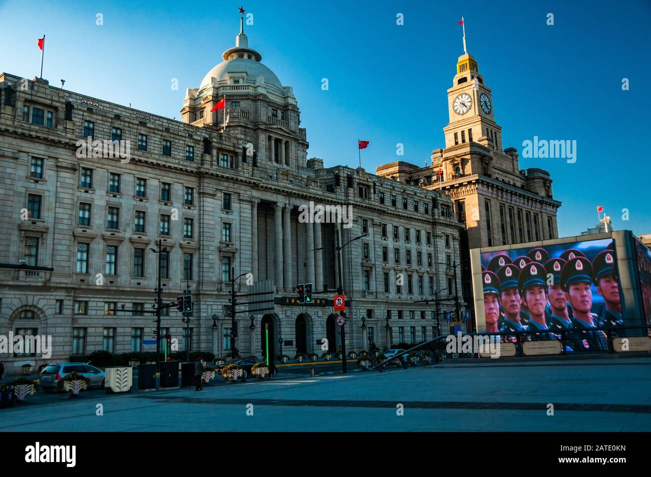 Rise of Chinese nationalism with a huge screen on Shanghai’s historic Bund showing propaganda of troops. Stock Photo