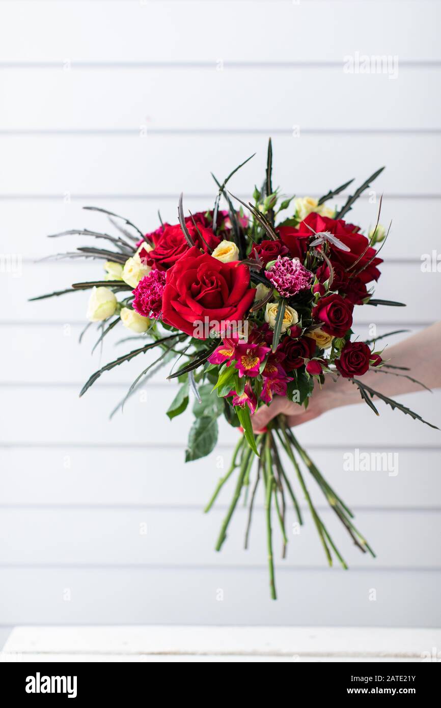 Beautiful bouquet of mixed flowers. The work of the florist. Flower delivery Stock Photo