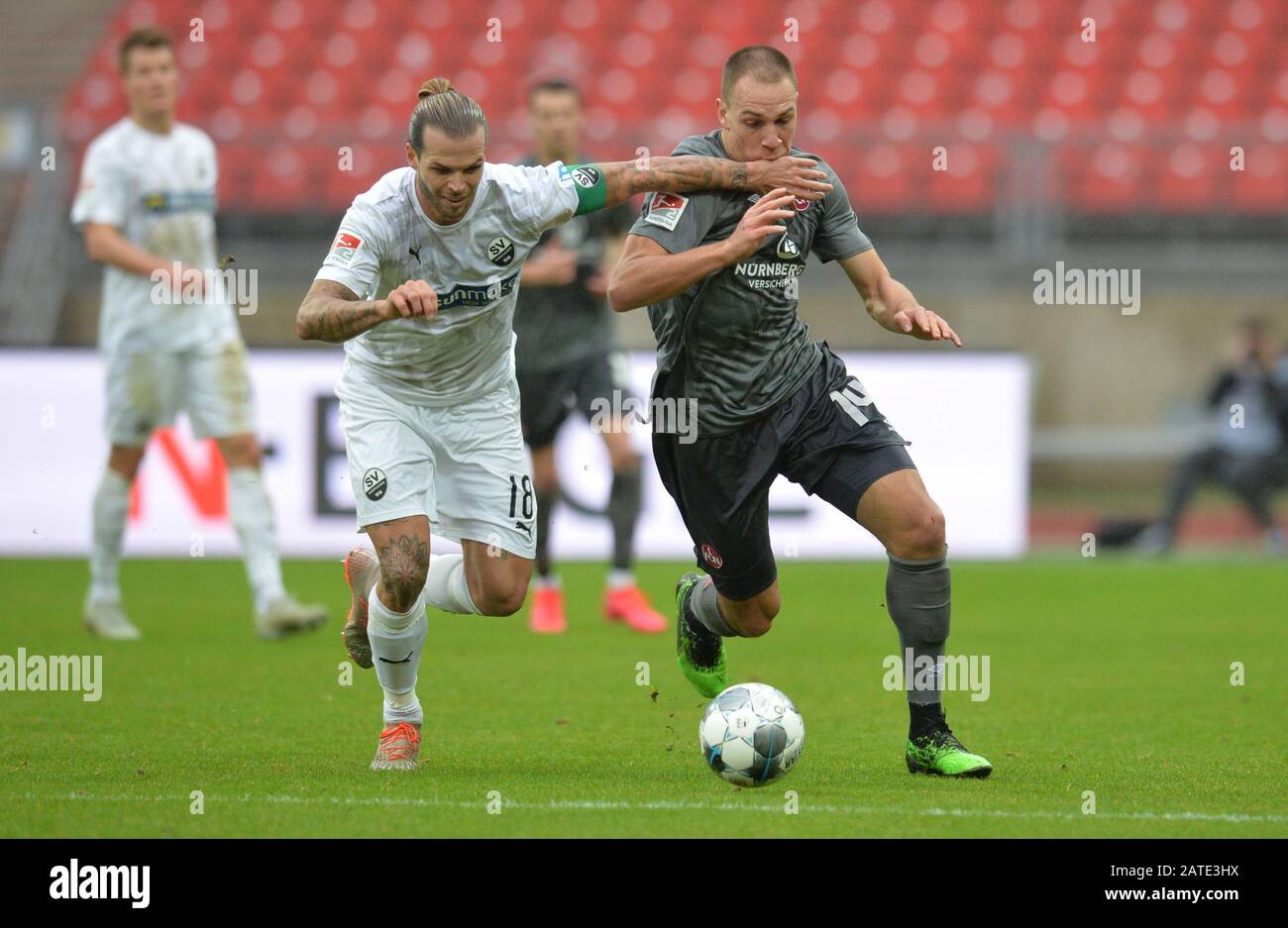 Nuremberg, Germany. 02nd Feb, 2020. Football: 2nd Bundesliga, 1st FC Nürnberg - SV Sandhausen, 20th matchday at the Max Morlock Stadium. Michael Frey from Nuremberg plays against Dennis Diekmeier (l) from Sandhausen. Credit: Timm Schamberger/dpa - IMPORTANT NOTE: In accordance with the regulations of the DFL Deutsche Fußball Liga and the DFB Deutscher Fußball-Bund, it is prohibited to exploit or have exploited in the stadium and/or from the game taken photographs in the form of sequence images and/or video-like photo series./dpa/Alamy Live News Stock Photo