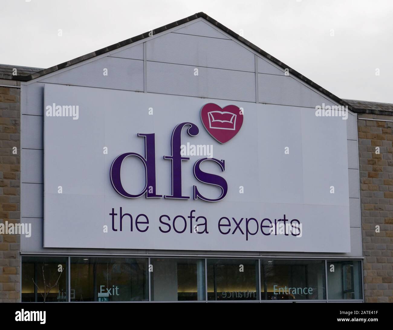 The shop front sign in white with blue writing and small red heart of DFS The Sofa Experts in Huddersfield Yorkshire England Stock Photo