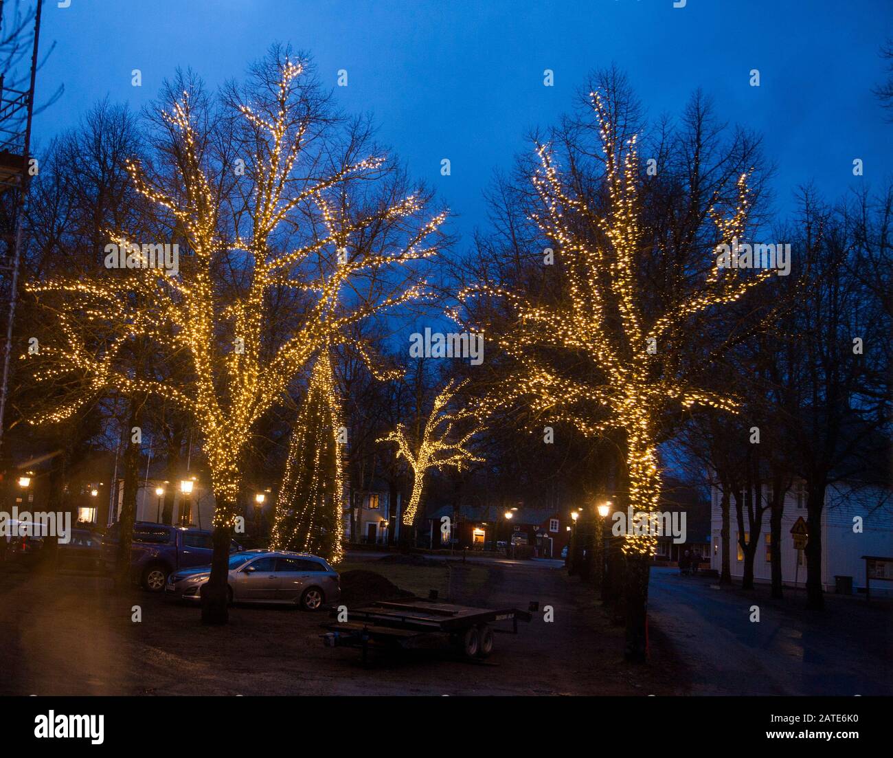 GRYTHYTTAN Gästgivaregård in Närke län Västmanland a church village since the Middle ages. Today more famous for its food culture and nature.Light decorations in the trees at the square Stock Photo