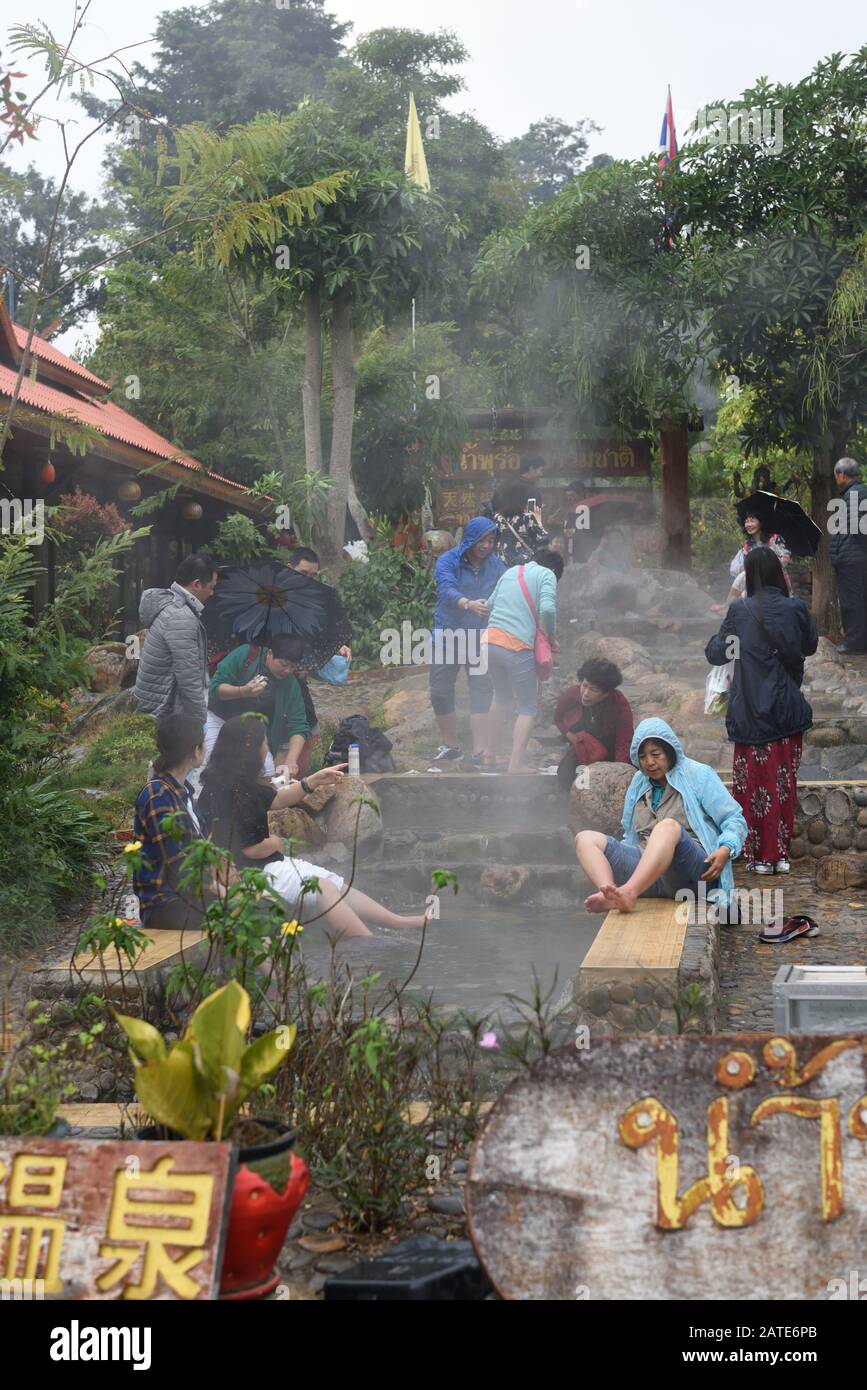 People enjoying the water of Thaweesin Hot Spring, Mae Chedi Mai, Chiang Rai Province, Thailand Stock Photo