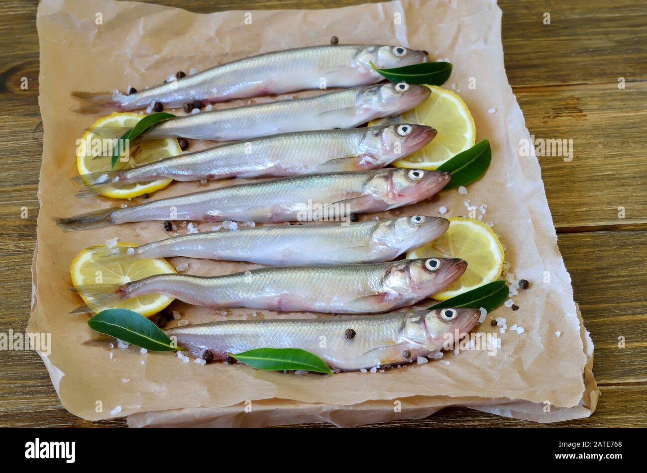 Fresh fish with spices on paper Stock Photo