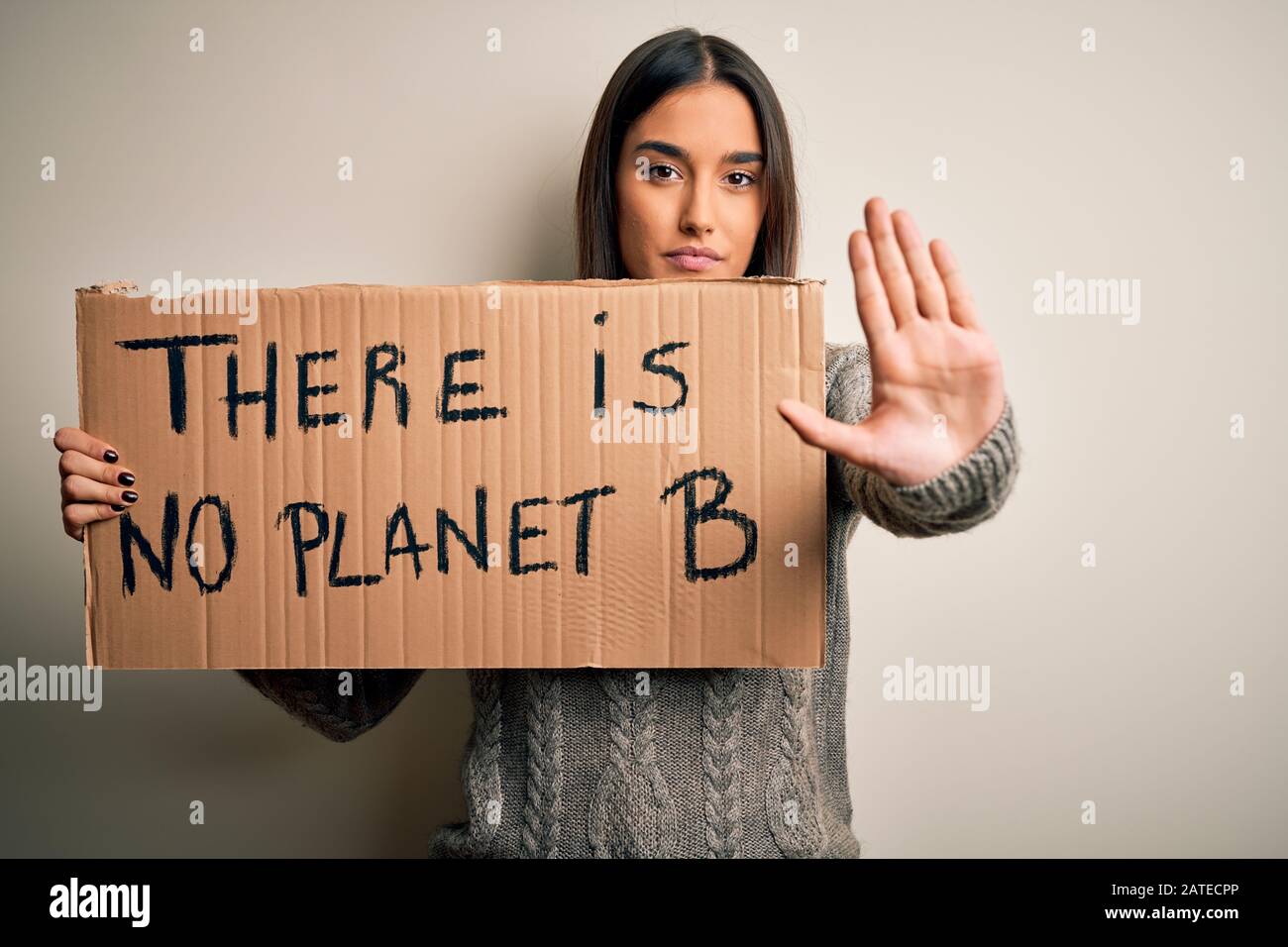 Young beautiful brunette activist woman protesting for save the planet ...