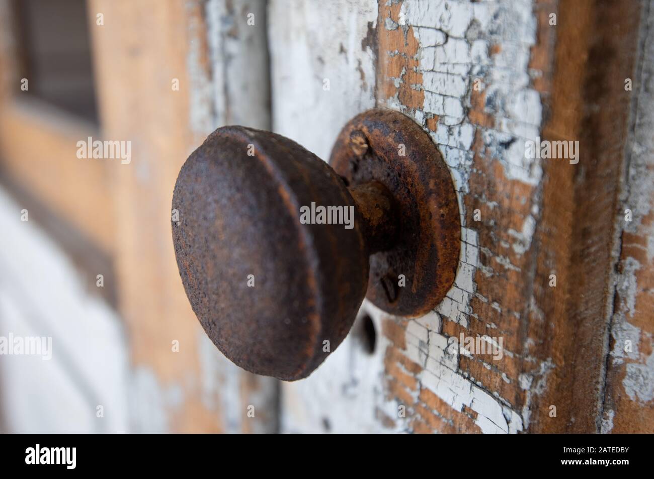 Rusty door knob and chipped paint Stock Photo