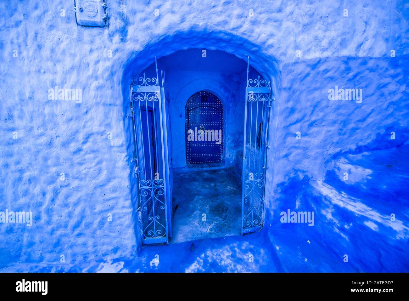 Traditional blue door on an old street inside Medina of Chefchaouen