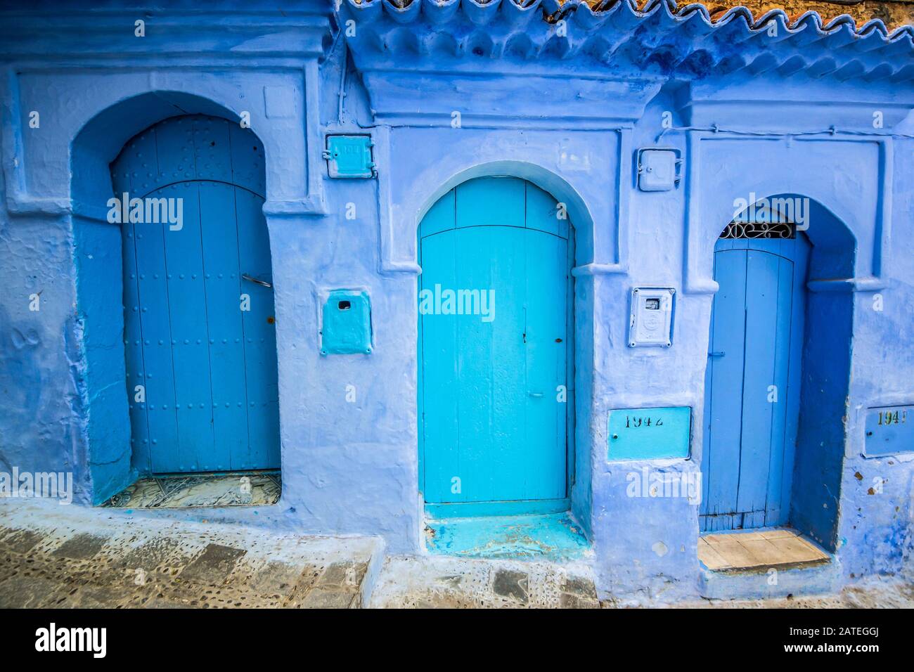 Traditional blue door on an old street inside Medina of Chefchaouen, Morocco Stock Photo