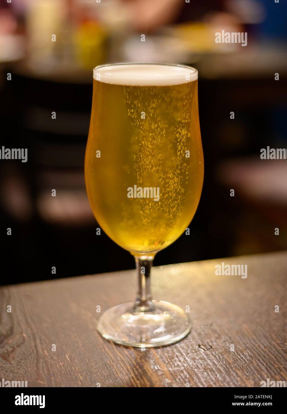 Misty glass with pint of cold yellow Scotch ale, pale ale draft beer in