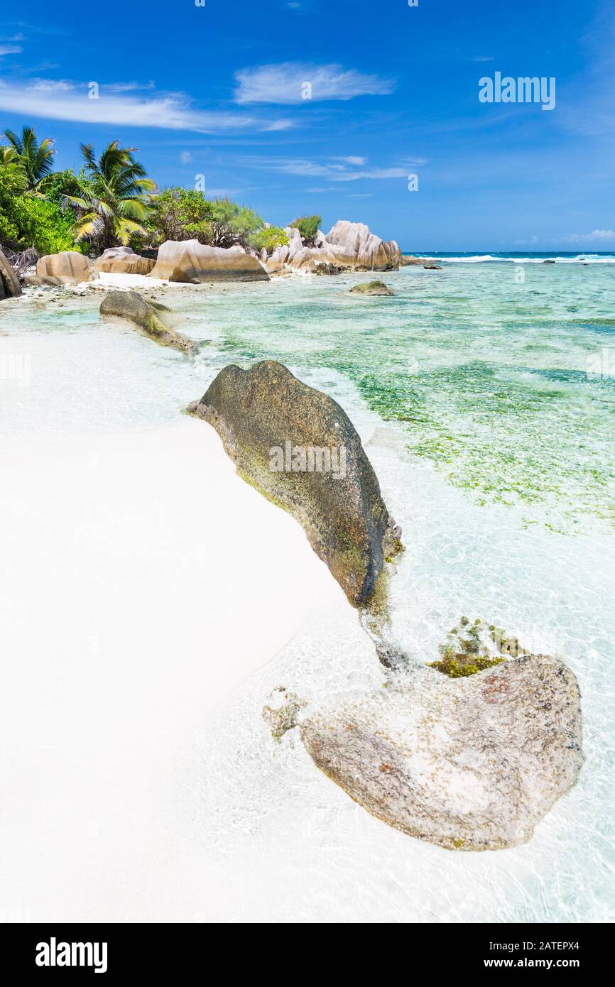The beautiful tropical beach Anse Source D'Argent in La Digue, Seychelles with clear water, granite rocks and palm trees Stock Photo