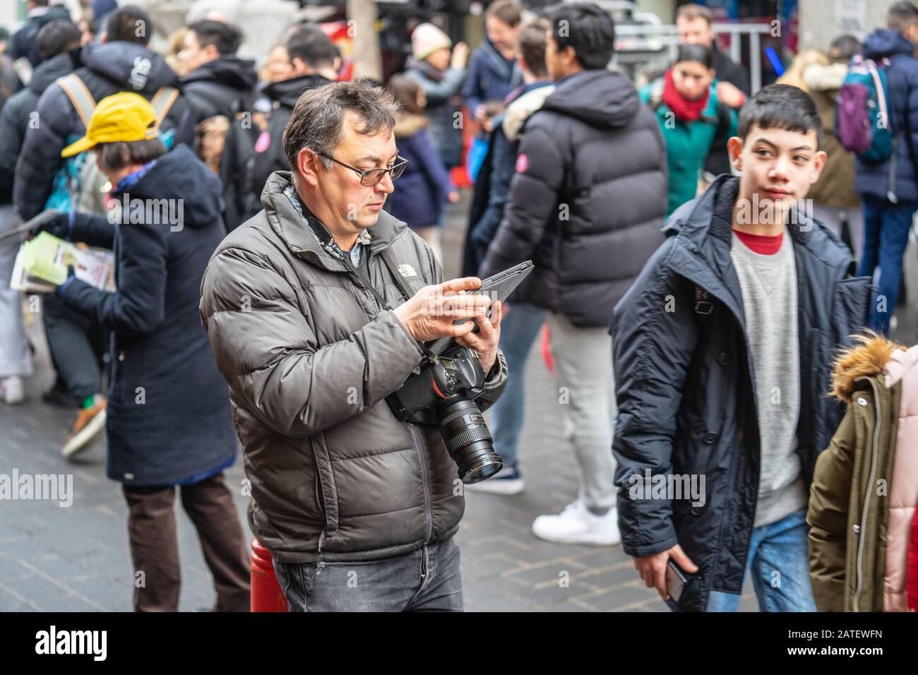 London, January 26, 2020. Photographer taking photos in London Chinatown. Chinese New Year Celebrations. Selective focus Stock Photo