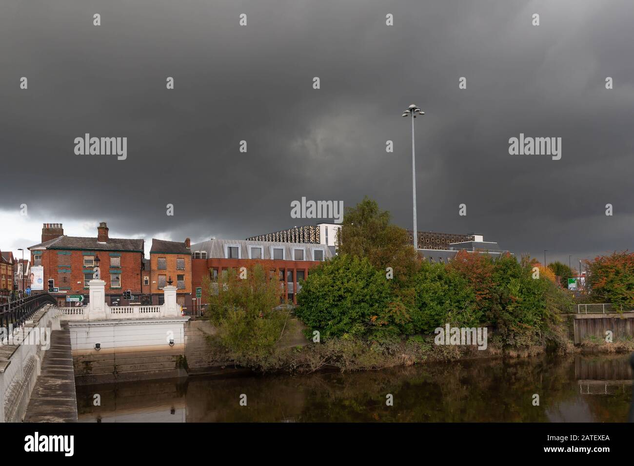 Stormy skies over the old Packet House and new multi-storey car park, Warrington, Cheshire, seen from Warrington Bridge over the River Mersey, 2019 Stock Photo