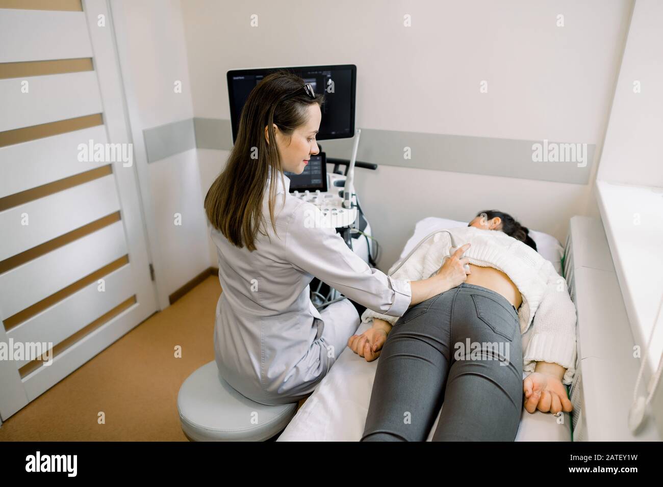 Ultrasound in physical therapy. Young woman therapist using ultrasound