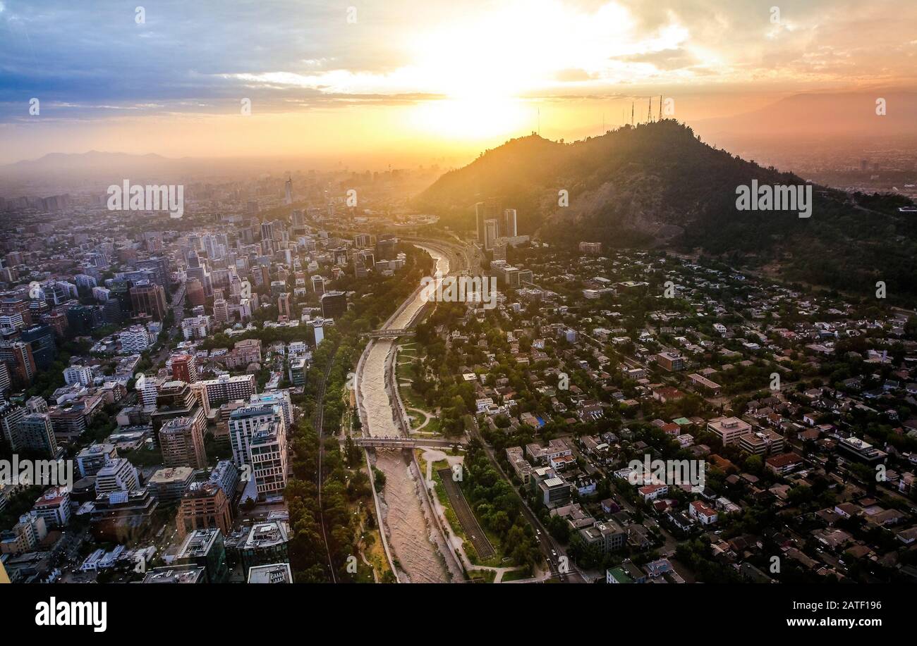 View of Santiago de Chile with Los Andes mountain range in the back at sunset time Stock Photo