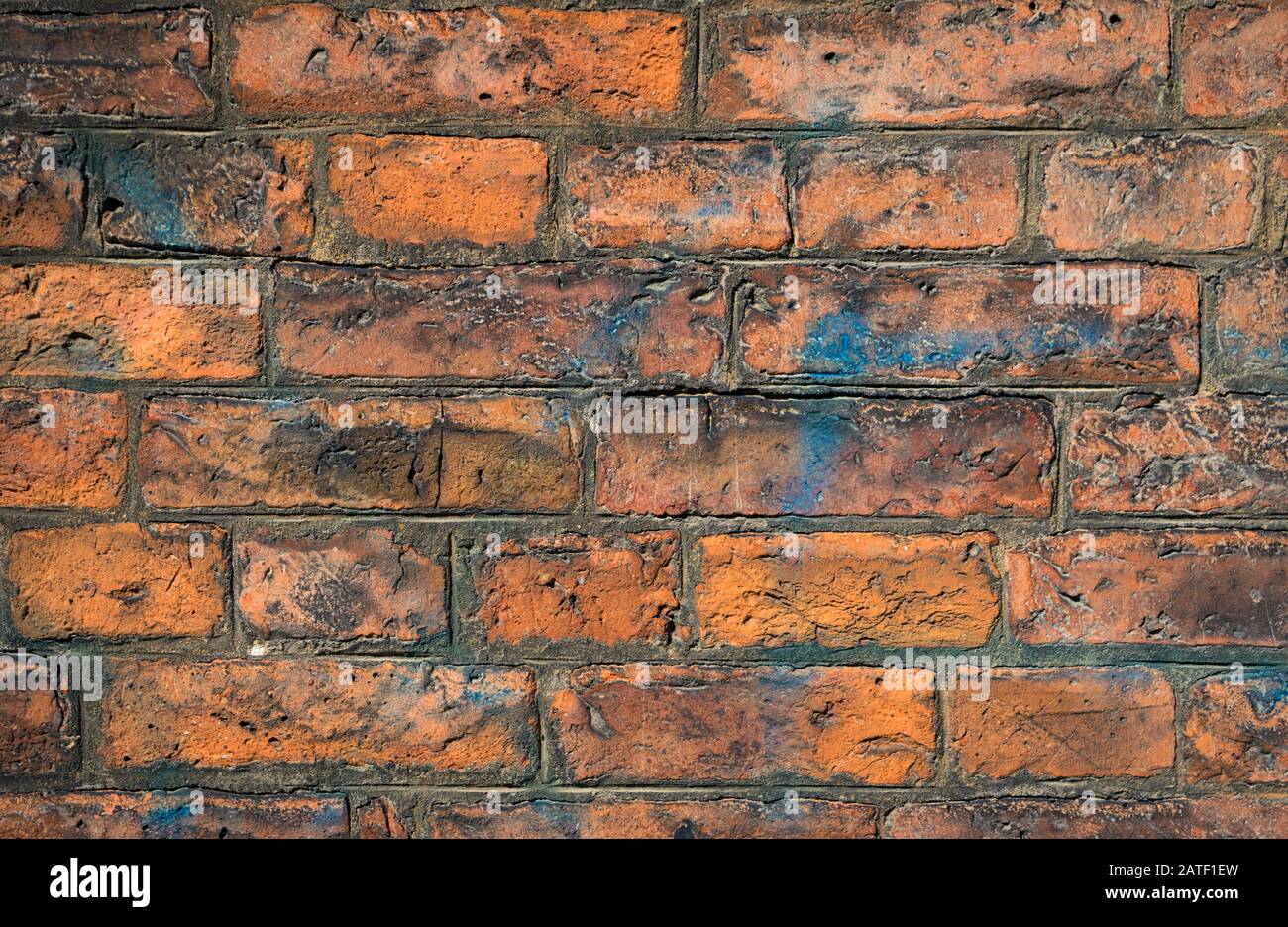 Brick wall in very textured brown tones stained with blue paint Stock Photo Alamy