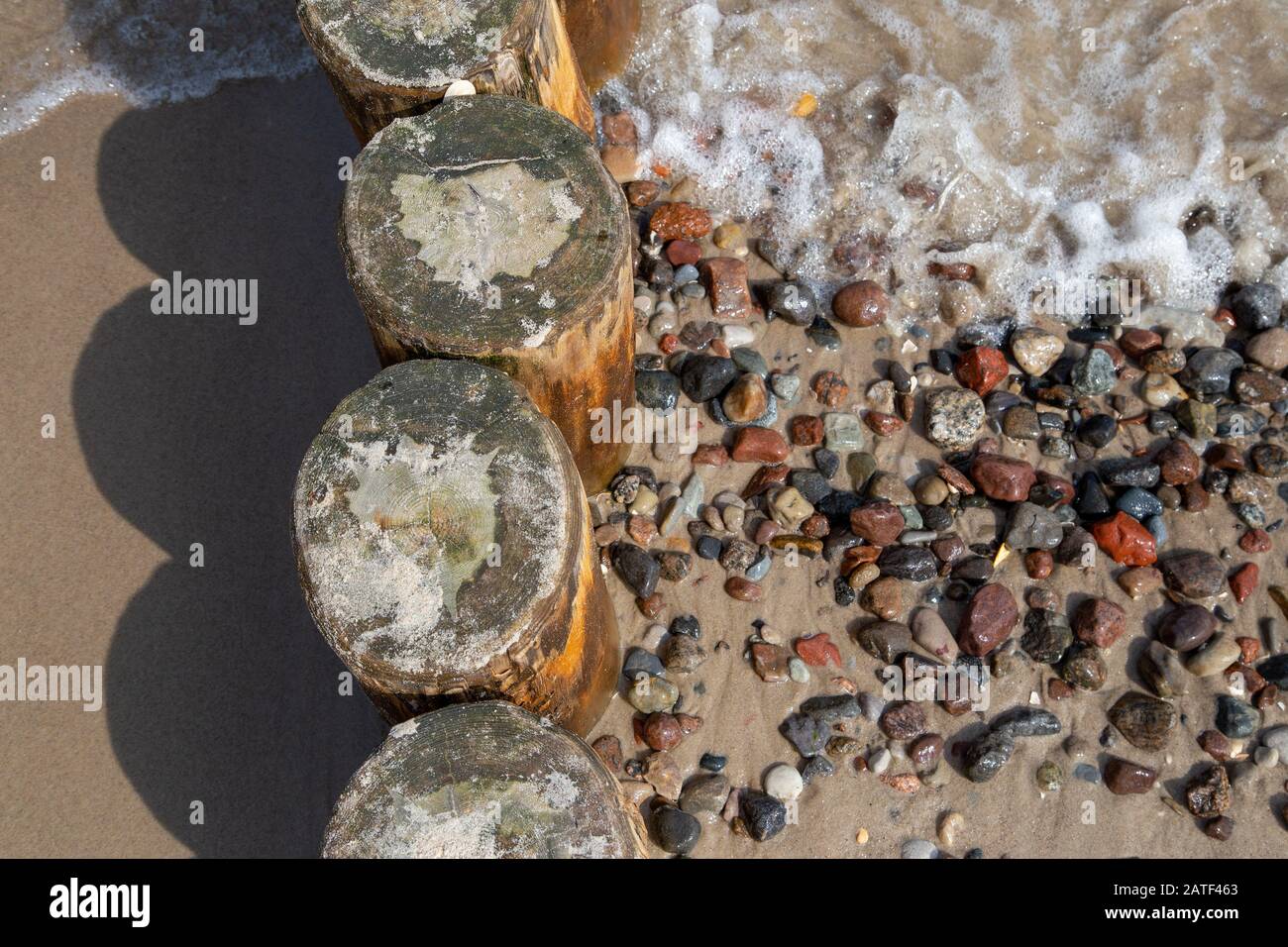 groynes with washed stones on the beach of the Baltic Sea in the seaside resort Zempin on Usedom Stock Photo