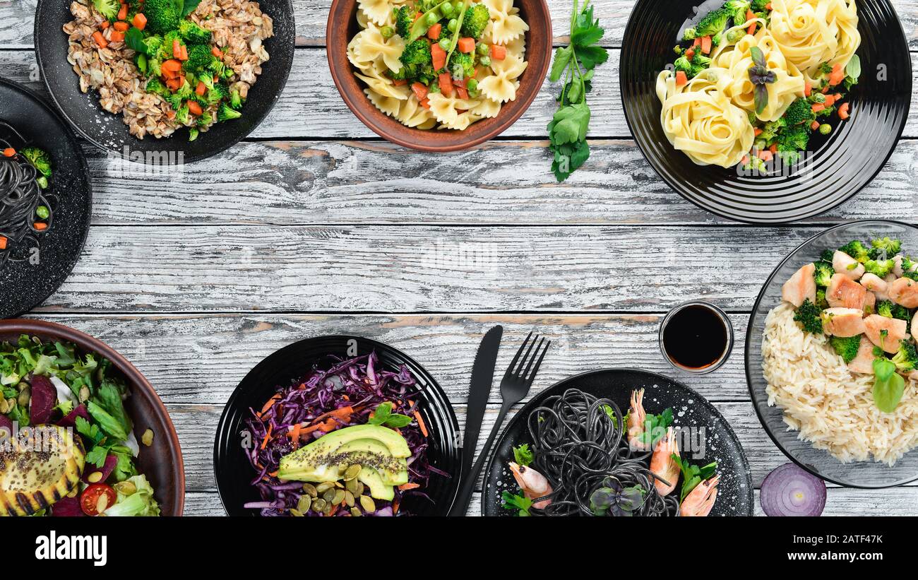 Food Background. Pasta, rice, risotto, salad. On a white wooden ...