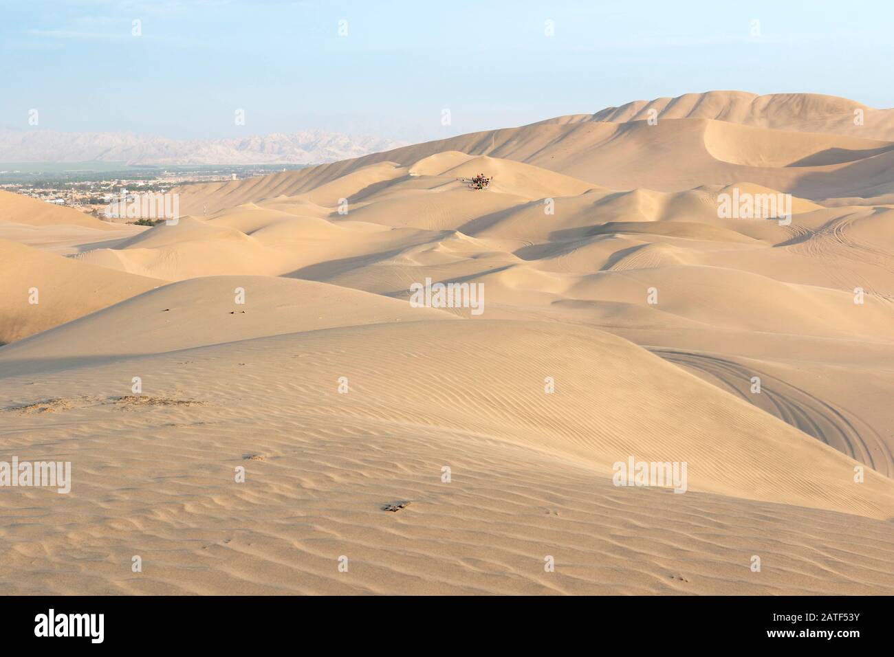 View of the Ica desert, a large and infinite large seen from the Huacachina where a group of tourists can also be seen in the distance Ica-Peru Stock Photo