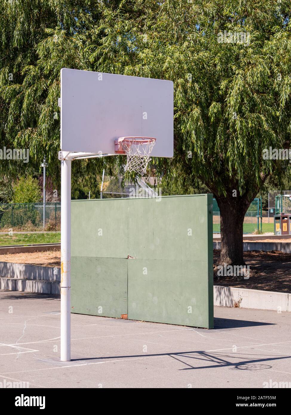 Short basketball hoop at public grade school playground recess area