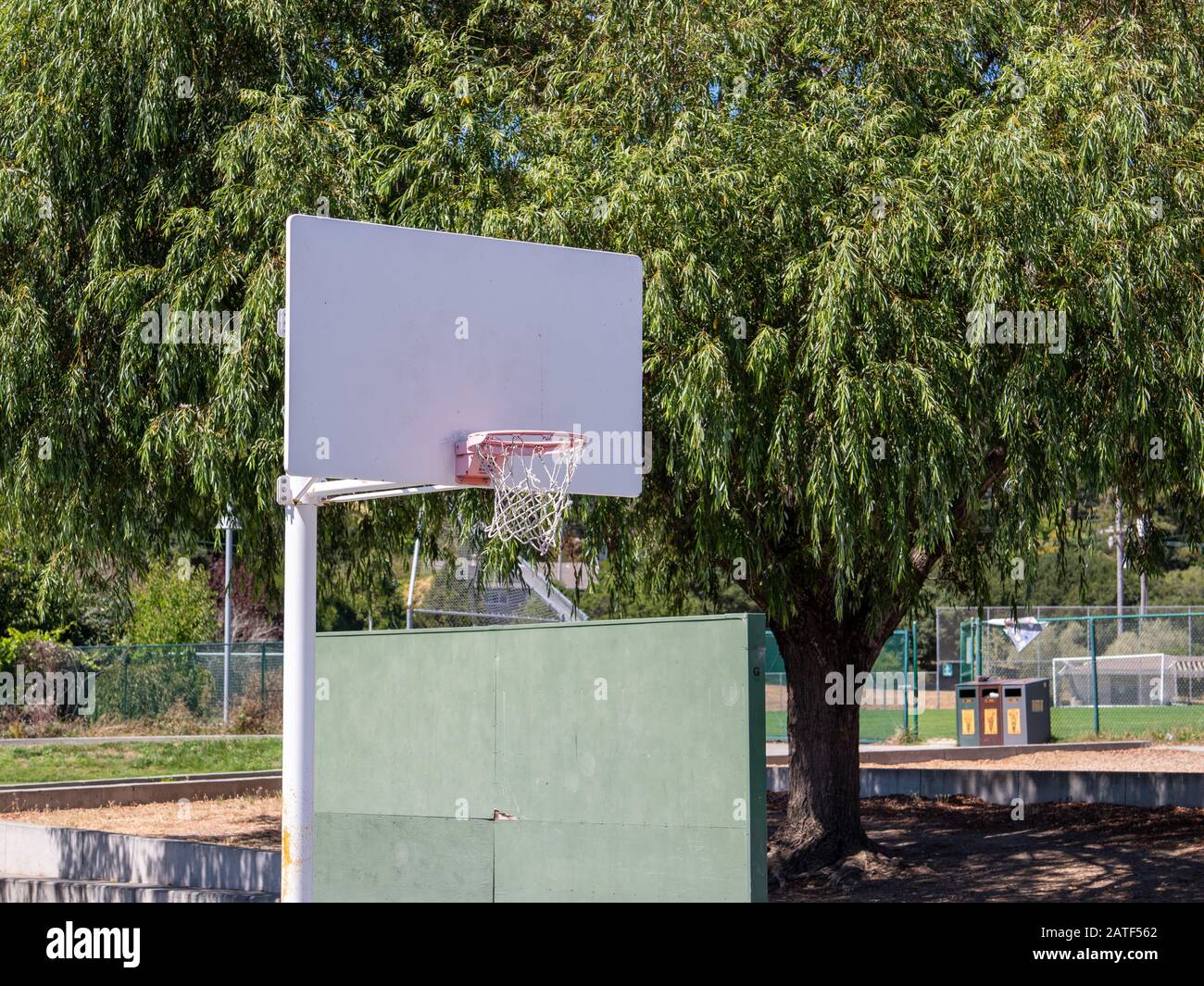 White basketball hoop in scenic playground park area outdoors Stock
