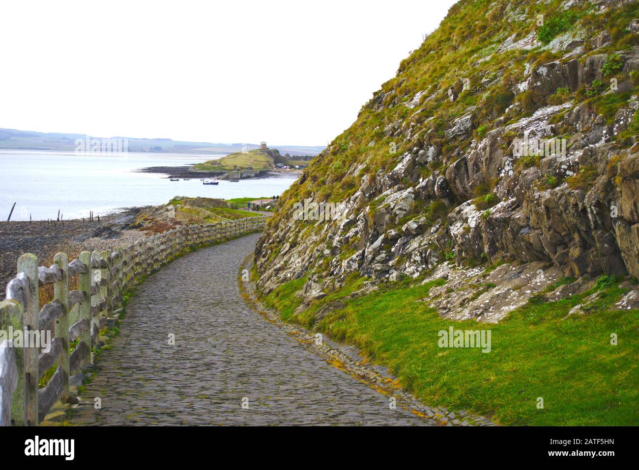 Path leading down from Lindisfarne Castle to Holy Island harbour, Northumberland, UK. Stock Photo